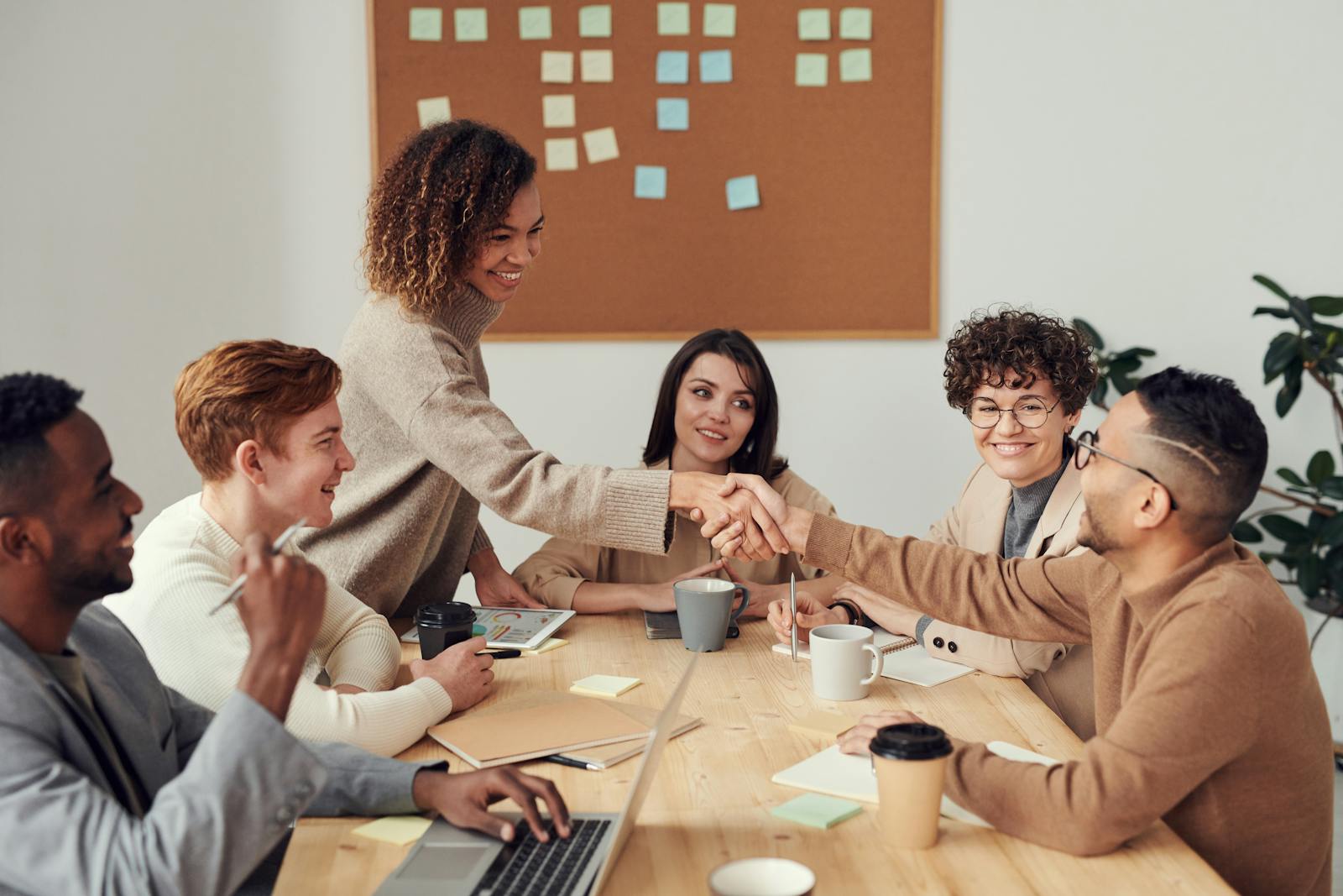 Colleagues shaking hands at a meeting about Heritage Bank Northwest personal banking