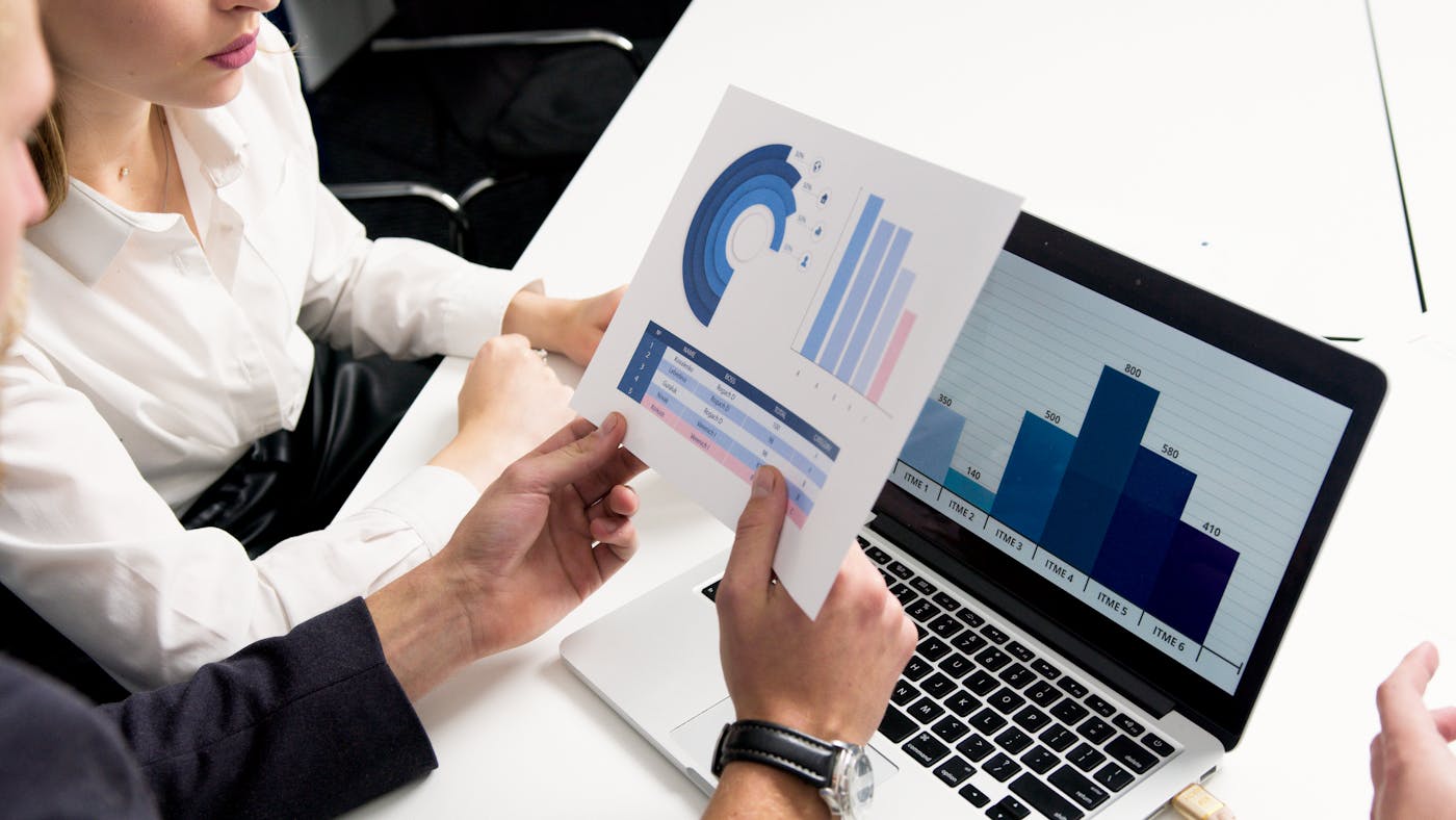 Laptop and printed charts illustrating Heritage Bank online banking