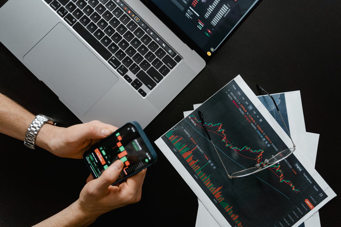 Phone and laptop on a desk, illustrating Heritage Bank mobile banking